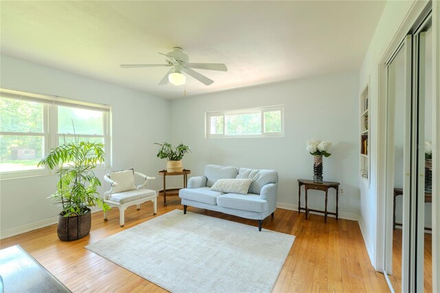 2001 Lily Ct, Sanford, FL 32771 - living room with light wood finished floors, a ceiling fan, and baseboards