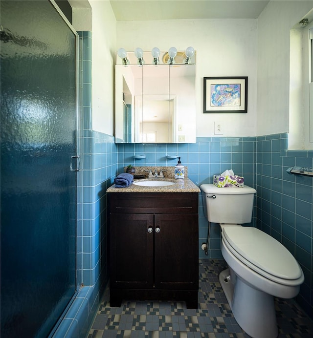 2001 Lily Ct, Sanford, FL 32771 - full bath with a shower stall, tile walls, a wainscoted wall, toilet, and vanity