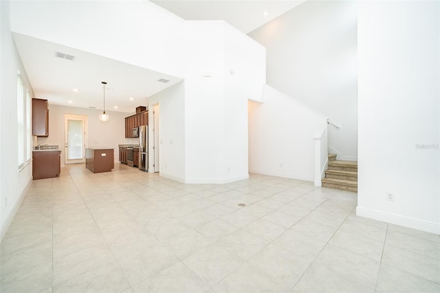 6132 Bimini Twist Loop, Orlando, FL 32819 - unfurnished living room featuring stairway, recessed lighting, light tile patterned floors, and baseboards