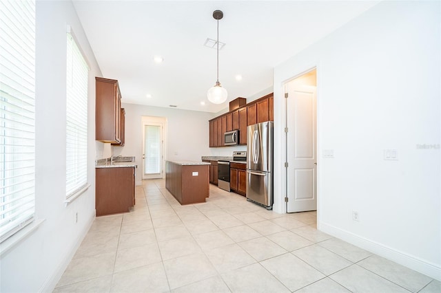 6132 Bimini Twist Loop, Orlando, FL 32819 - kitchen with stainless steel appliances, a kitchen island, baseboards, pendant lighting, and recessed lighting