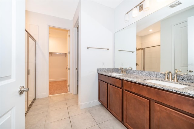 6132 Bimini Twist Loop, Orlando, FL 32819 - full bathroom with a shower stall, a spacious closet, tile patterned floors, double vanity, and baseboards