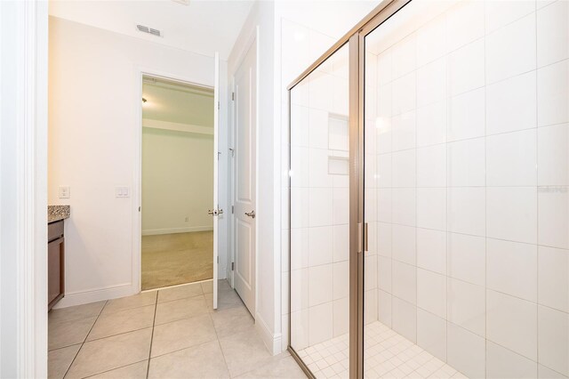 6132 Bimini Twist Loop, Orlando, FL 32819 - bathroom featuring vanity, a stall shower, tile patterned flooring, and baseboards
