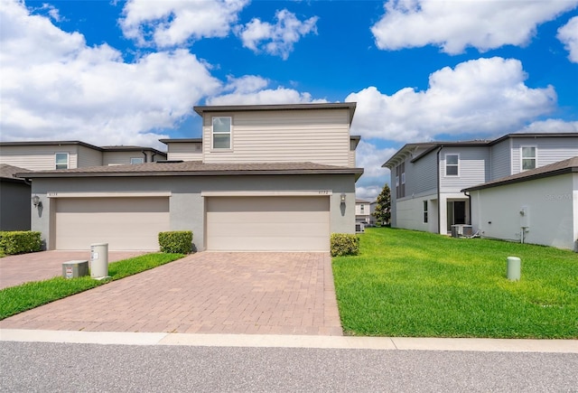 6132 Bimini Twist Loop, Orlando, FL 32819 - view of front of property with decorative driveway, a front lawn, cooling unit, and stucco siding