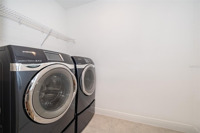 6132 Bimini Twist Loop, Orlando, FL 32819 - clothes washing area with independent washer and dryer, baseboards, and light tile patterned floors