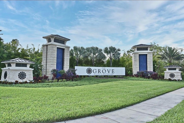 community / neighborhood sign with a yard