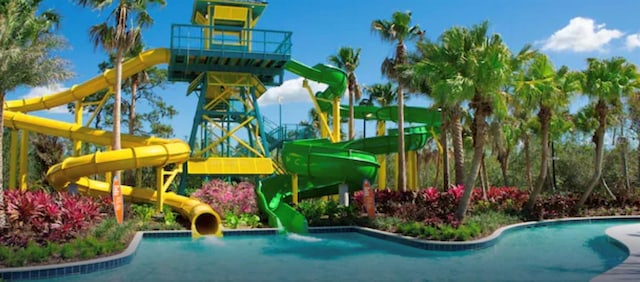 view of play area featuring a community pool and a water play area