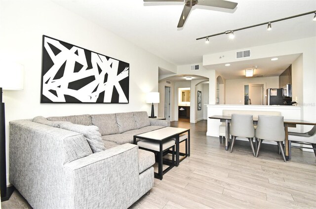 14501 Grove Resort Ave Unit 3741, Winter Garden, FL 34787 - living area with arched walkways, light wood-style flooring, a ceiling fan, and track lighting