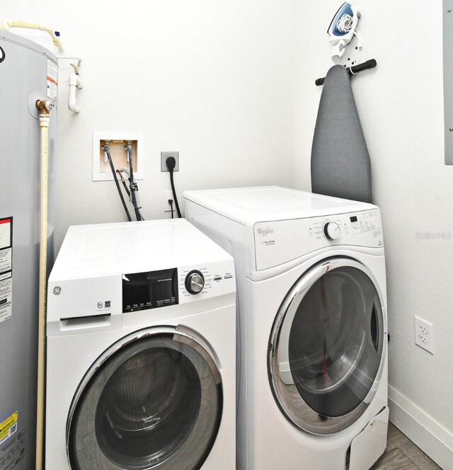 14501 Grove Resort Ave Unit 3741, Winter Garden, FL 34787 - clothes washing area with electric water heater, washer and dryer, and baseboards