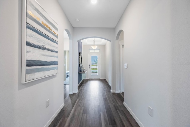 1974 Walnut Creek Dr, Kissimmee, FL 34744 - corridor featuring arched walkways, dark wood-style floors, and baseboards