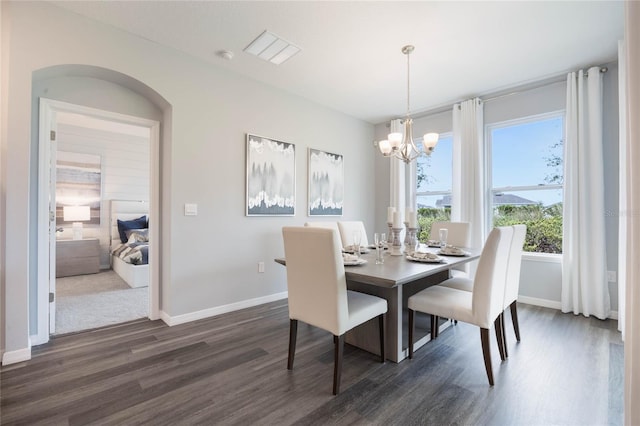1974 Walnut Creek Dr, Kissimmee, FL 34744 - dining space featuring dark wood-type flooring, a chandelier, and baseboards