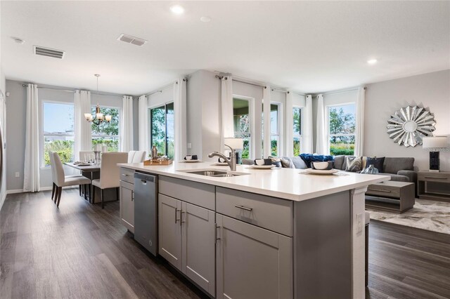 1974 Walnut Creek Dr, Kissimmee, FL 34744 - kitchen featuring gray cabinetry, stainless steel dishwasher, a sink, dark wood-style flooring, and light countertops
