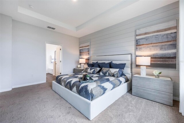 1974 Walnut Creek Dr, Kissimmee, FL 34744 - bedroom featuring carpet floors, a raised ceiling, wood walls, baseboards, and connected bathroom