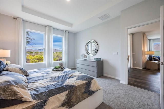 1974 Walnut Creek Dr, Kissimmee, FL 34744 - carpeted bedroom with a tray ceiling and baseboards