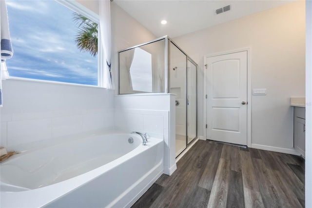 1974 Walnut Creek Dr, Kissimmee, FL 34744 - full bath with wood finished floors, a shower stall, a bath, vanity, and baseboards