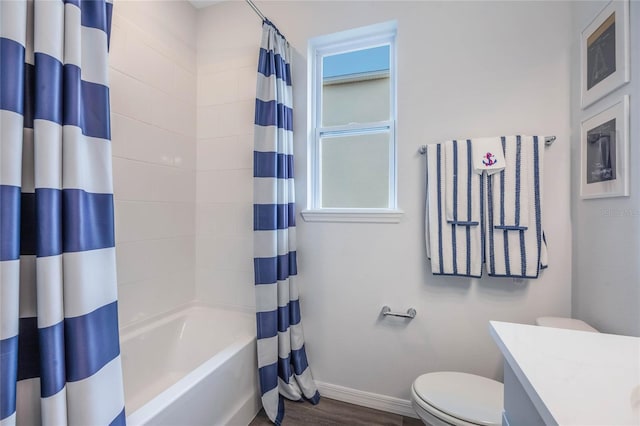 1974 Walnut Creek Dr, Kissimmee, FL 34744 - full bath with baseboards, toilet, shower / bath combination with curtain, wood finished floors, and vanity