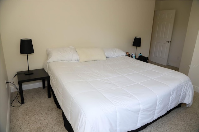 carpeted bedroom featuring baseboards
