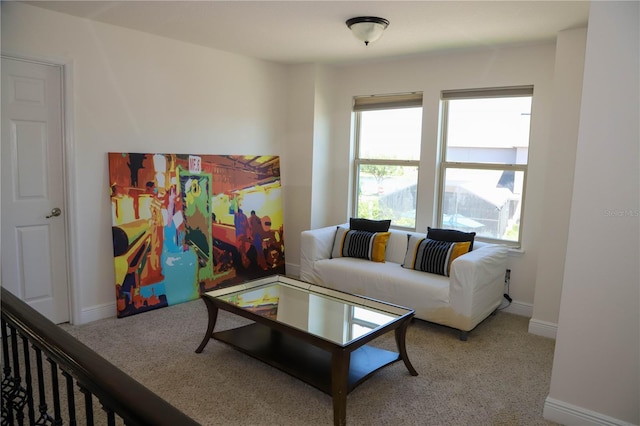 carpeted living room featuring baseboards