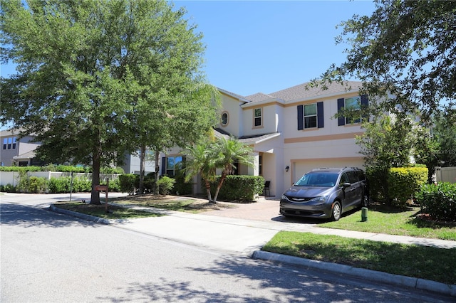 9005 Reflection Pointe Dr, Windermere, FL 34786 - view of front facade with stucco siding, a garage, and concrete driveway