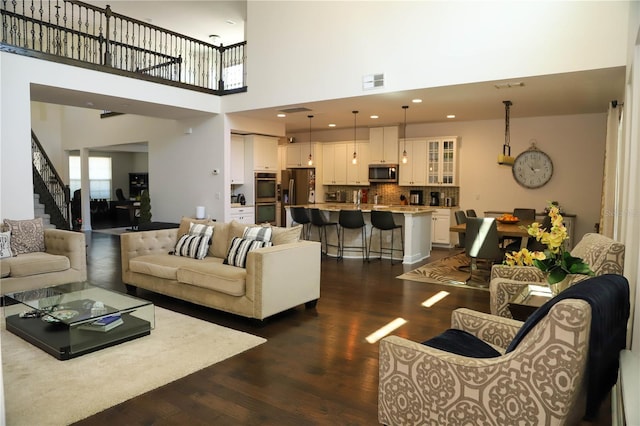 9005 Reflection Pointe Dr, Windermere, FL 34786 - living area with dark wood-style floors, stairs, and a towering ceiling
