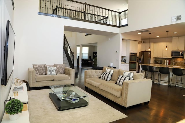 9005 Reflection Pointe Dr, Windermere, FL 34786 - living area featuring stairway, a towering ceiling, and dark wood-style floors