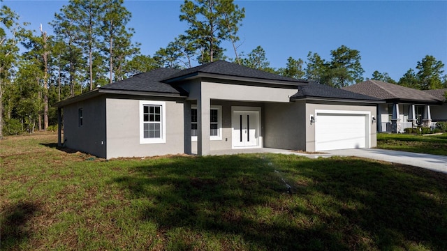 view of front of property with stucco siding, an attached garage, and a front lawn