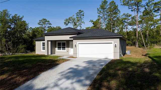 ranch-style home with stucco siding, an attached garage, a front yard, and roof with shingles