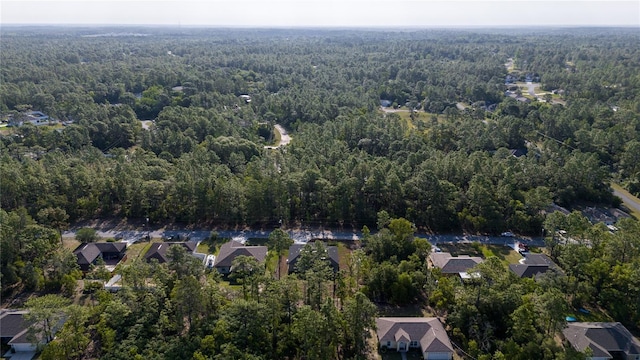 aerial view of property and surrounding area with a forest