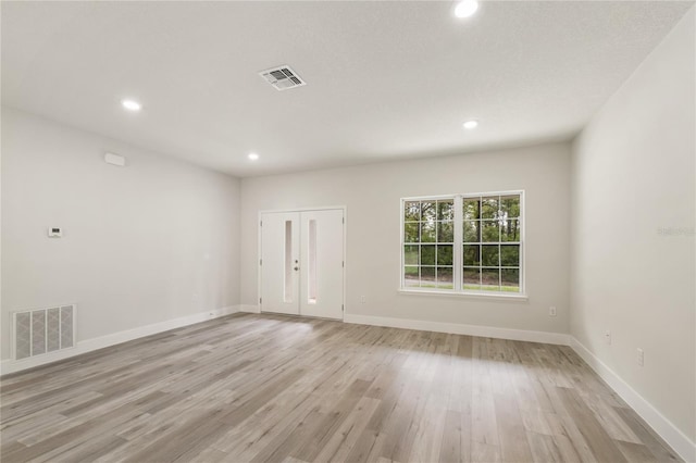 empty room with recessed lighting, light wood-style floors, and baseboards