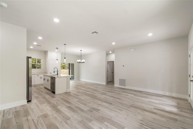 unfurnished living room featuring recessed lighting, light wood-type flooring, a chandelier, baseboards, and a sink