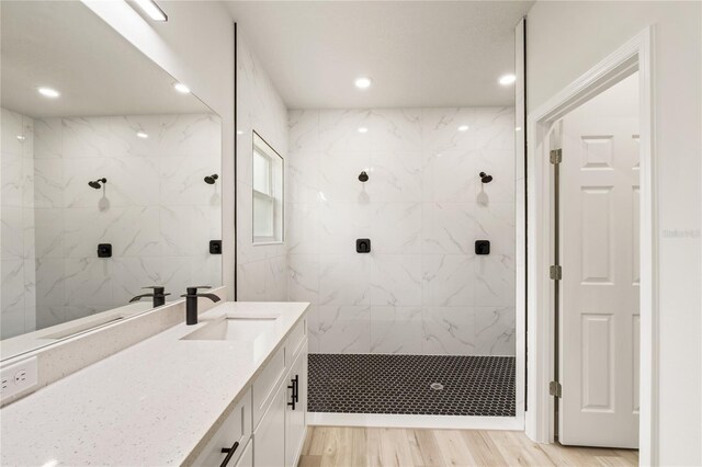 full bathroom featuring a stall shower, vanity, recessed lighting, and wood finished floors