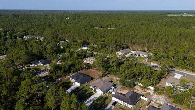 aerial view of property's location featuring a forest
