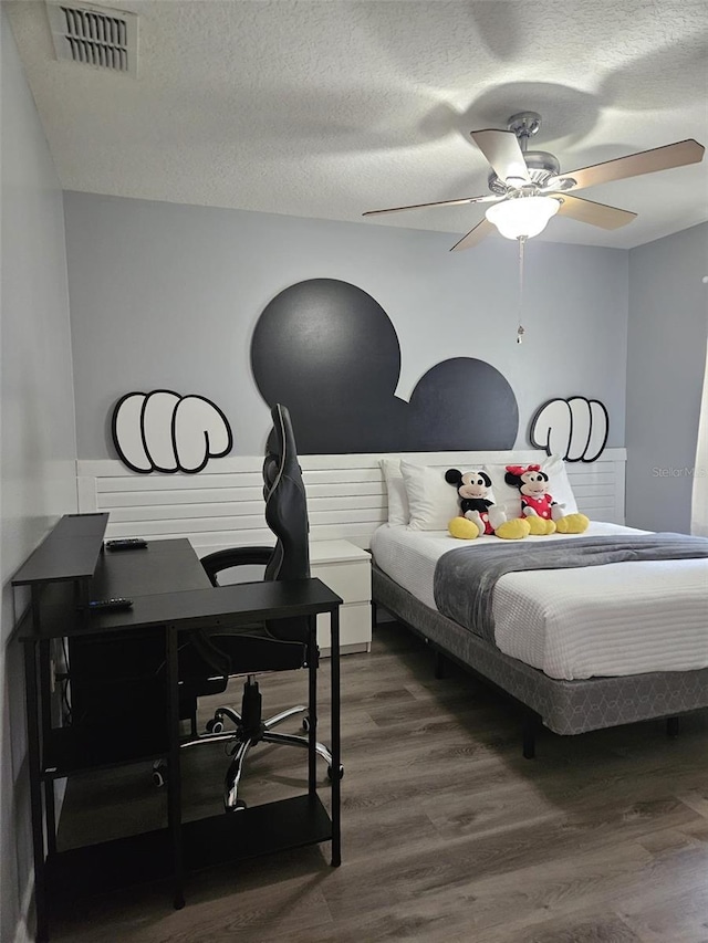 3193 Yellow Lantana Ln, Kissimmee, FL 34747 - bedroom with dark wood-style flooring, an office area, a textured ceiling, and ceiling fan