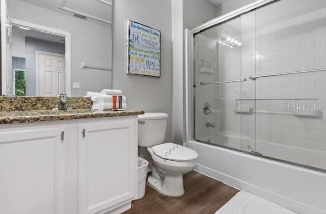 3193 Yellow Lantana Ln, Kissimmee, FL 34747 - bathroom featuring wood finished floors, enclosed tub / shower combo, toilet, and vanity