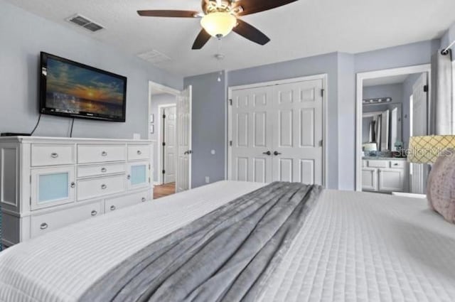3193 Yellow Lantana Ln, Kissimmee, FL 34747 - bedroom with a closet, a ceiling fan, and ensuite bath
