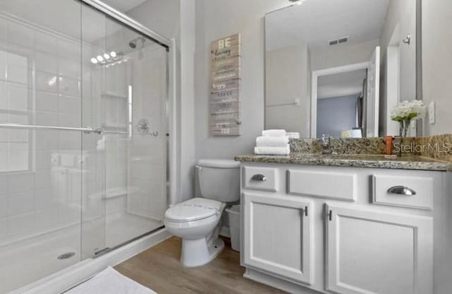 3193 Yellow Lantana Ln, Kissimmee, FL 34747 - bathroom featuring wood finished floors, toilet, a shower stall, and vanity