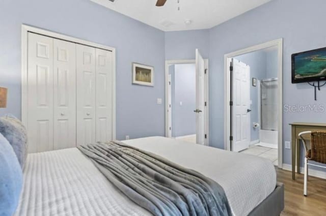 3193 Yellow Lantana Ln, Kissimmee, FL 34747 - bedroom featuring a closet, wood finished floors, ceiling fan, connected bathroom, and baseboards