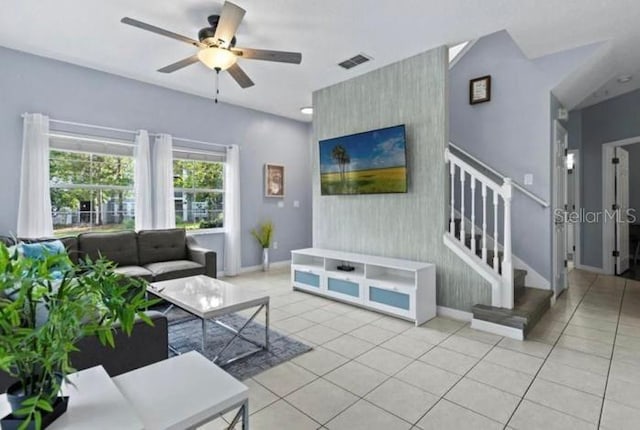 3193 Yellow Lantana Ln, Kissimmee, FL 34747 - living area featuring an accent wall, stairway, baseboards, and ceiling fan