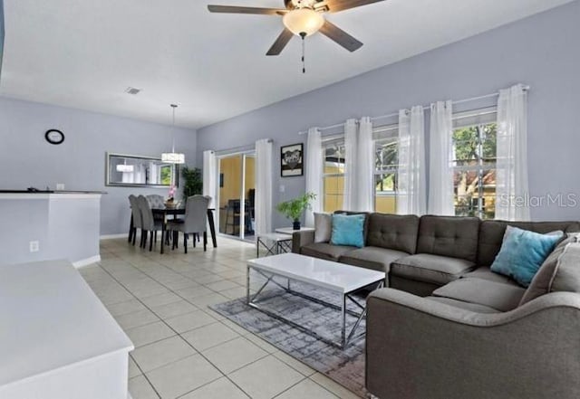 3193 Yellow Lantana Ln, Kissimmee, FL 34747 - living room with light tile patterned floors, a ceiling fan, and baseboards