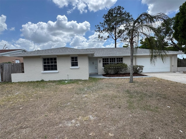 6624 Kristin Ct, Orlando, FL 32818 - ranch-style house with an attached garage, driveway, fence, and stucco siding