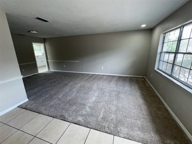 6624 Kristin Ct, Orlando, FL 32818 - empty room with carpet, healthy amount of natural light, a textured ceiling, and baseboards
