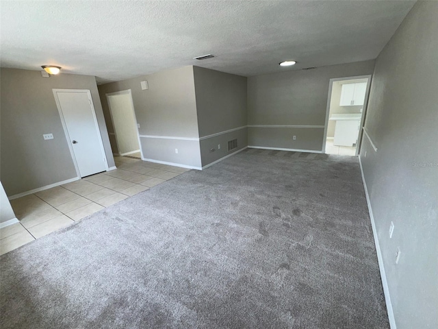 6624 Kristin Ct, Orlando, FL 32818 - spare room featuring a textured ceiling, baseboards, tile patterned flooring, and carpet
