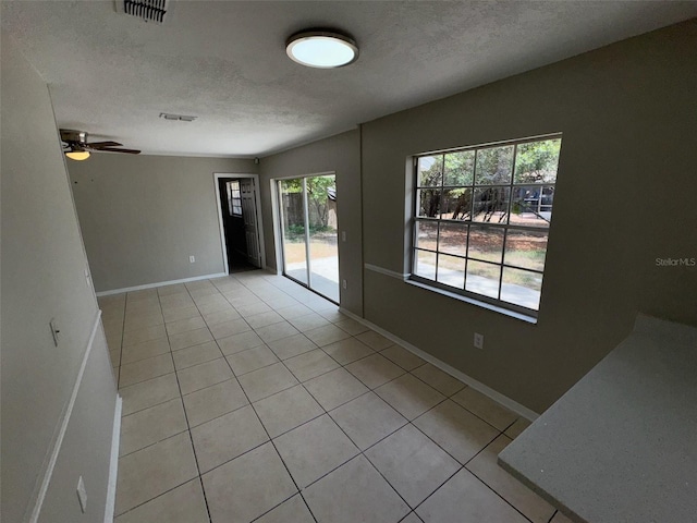 6624 Kristin Ct, Orlando, FL 32818 - unfurnished room with light tile patterned floors, a textured ceiling, a ceiling fan, and baseboards