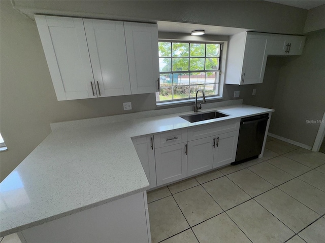 6624 Kristin Ct, Orlando, FL 32818 - kitchen with black dishwasher, a sink, white cabinetry, light stone countertops, and light tile patterned floors