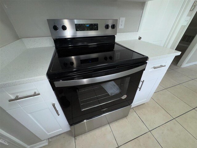 6624 Kristin Ct, Orlando, FL 32818 - kitchen view of electric stove and white cabinetry