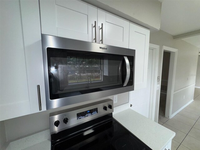 6624 Kristin Ct, Orlando, FL 32818 - kitchen view of appliances with stainless steel finishes, white cabinetry, and light countertops