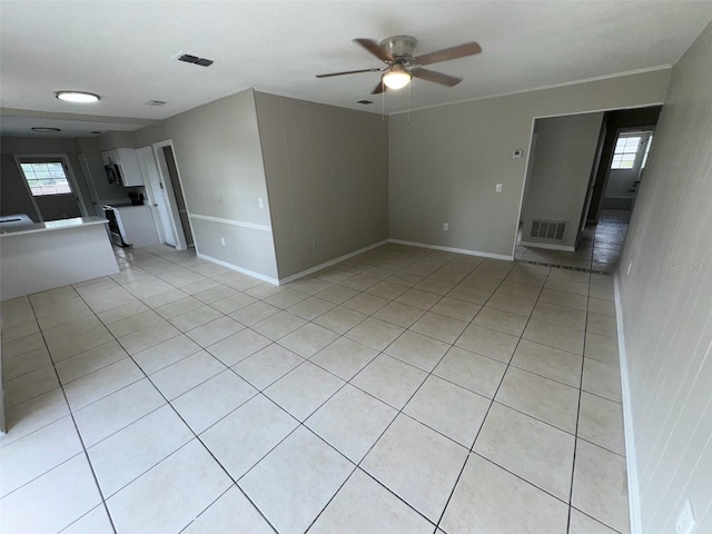 6624 Kristin Ct, Orlando, FL 32818 - unfurnished living room with ceiling fan, light tile patterned floors, and baseboards
