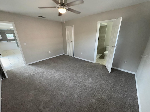 6624 Kristin Ct, Orlando, FL 32818 - unfurnished bedroom featuring dark colored carpet, baseboards, ensuite bath, a ceiling fan, and dark tile patterned flooring