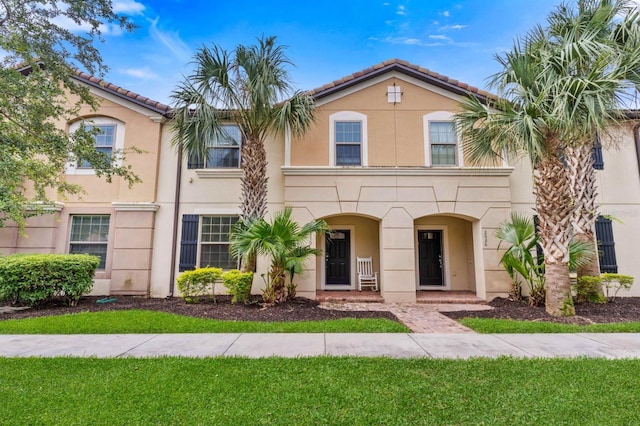 2030 Majorca Dr, Kissimmee, FL 34747 - view of property featuring stucco siding, a tile roof, and a porch