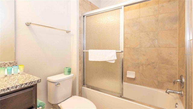 2030 Majorca Dr, Kissimmee, FL 34747 - full bathroom featuring vanity, shower / bath combination with glass door, and toilet