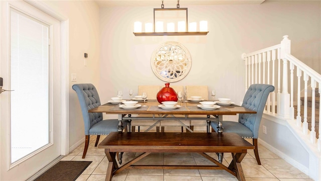 2030 Majorca Dr, Kissimmee, FL 34747 - dining space with light tile patterned floors, stairway, and baseboards